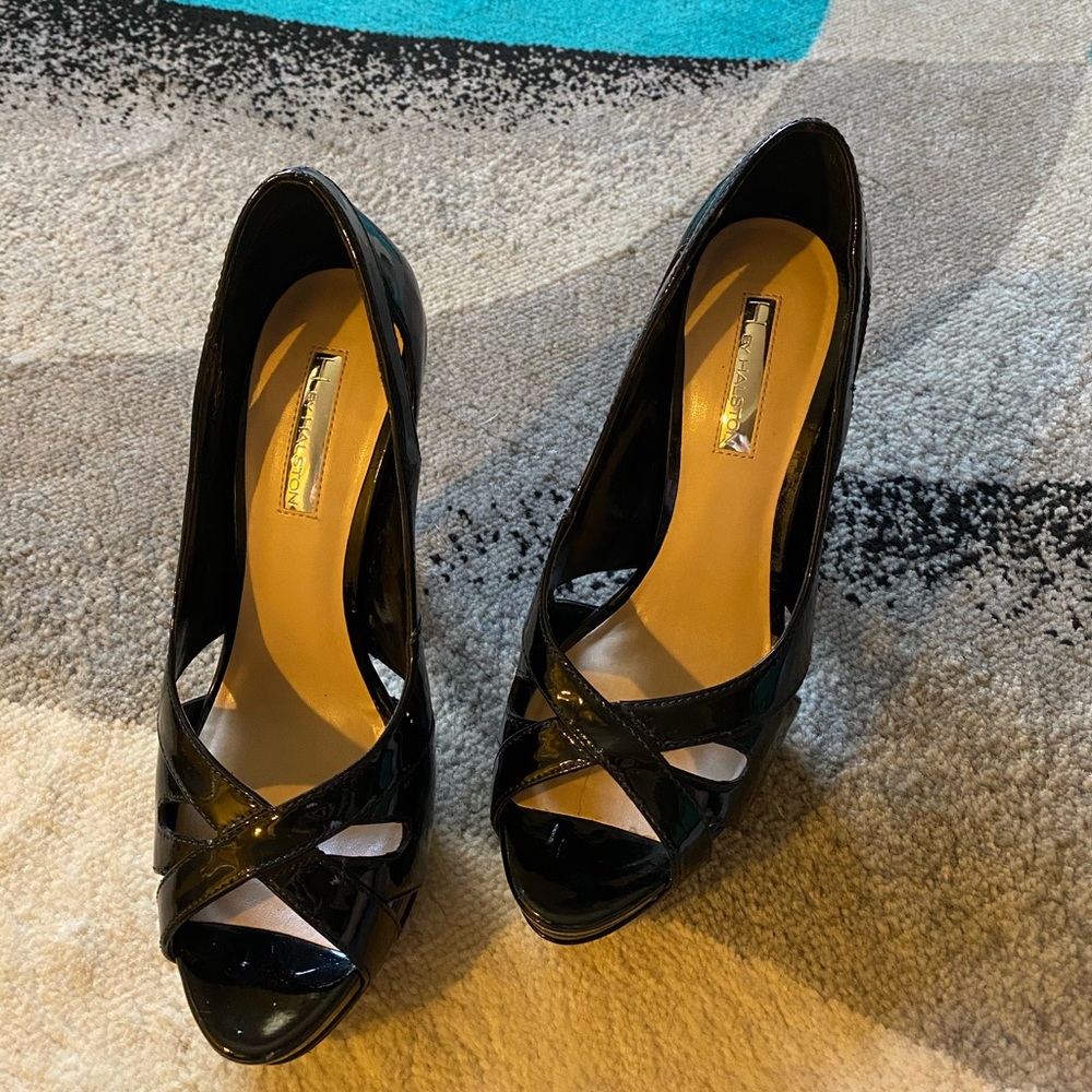 Black patent leather peep toe pumps